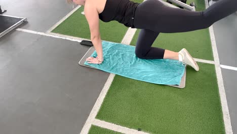 slow-motion gym workout of woman doing bird dog exercise