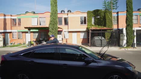 Man-working-on-cleaning-a-car