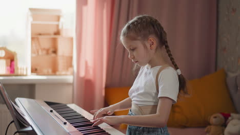 Calm-girl-in-orthopedic-corset-plays-slow-melody-on-piano