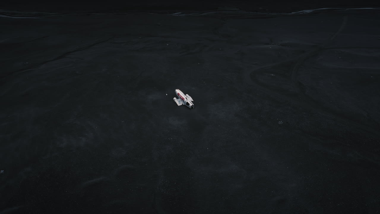 Abandoned Plane in Black Sand Wasteland