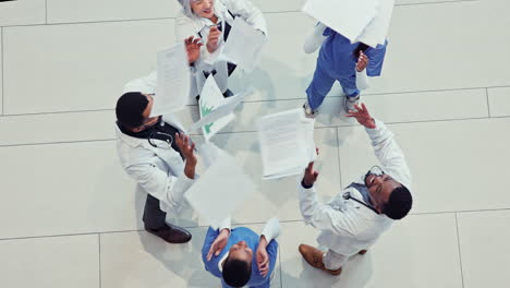 healthcare, doctor team and celebrate with paper