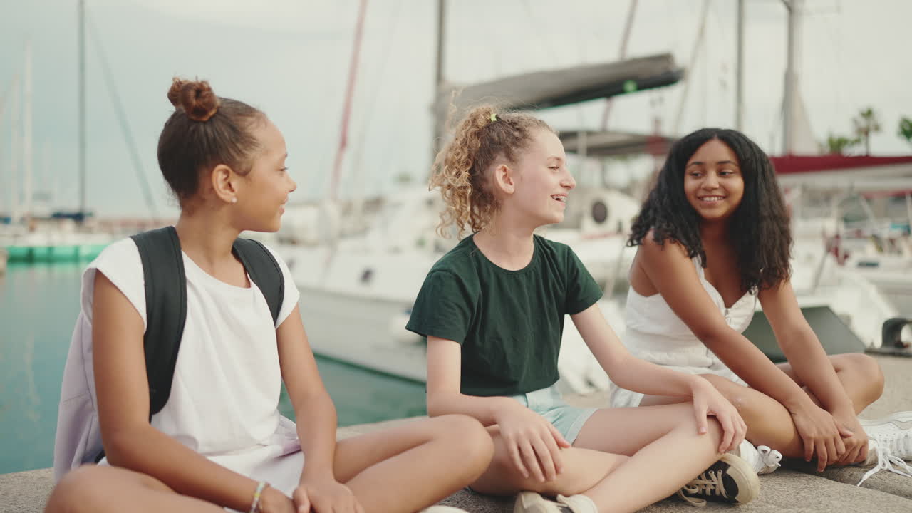 Three girls hanging out at the marina