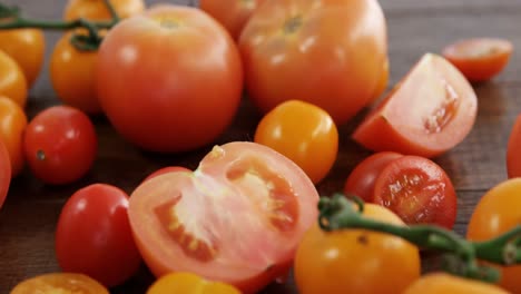 grapes of yellow tomatoes and red cherry tomatoes diced on wooden table background