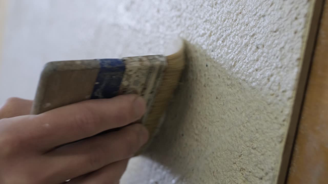 Applying plaster to wall