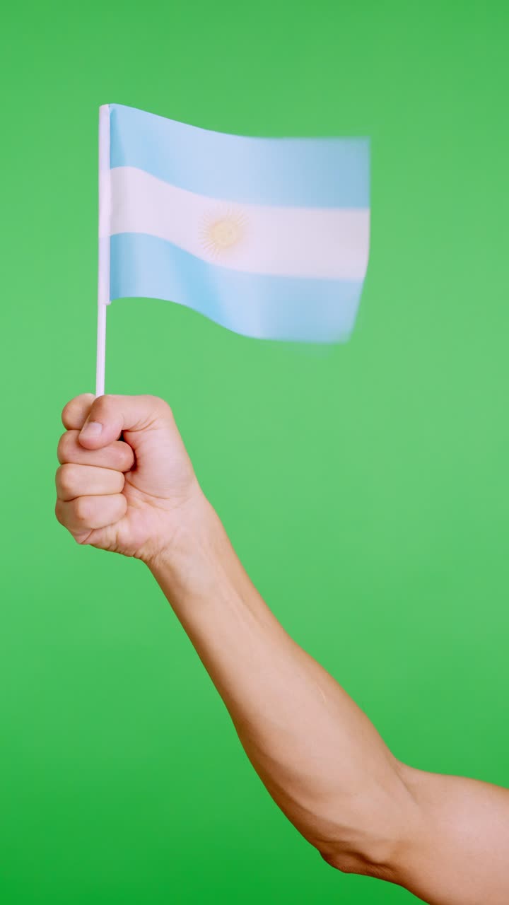 Hand lifting a argentine pennant while waving by the wind