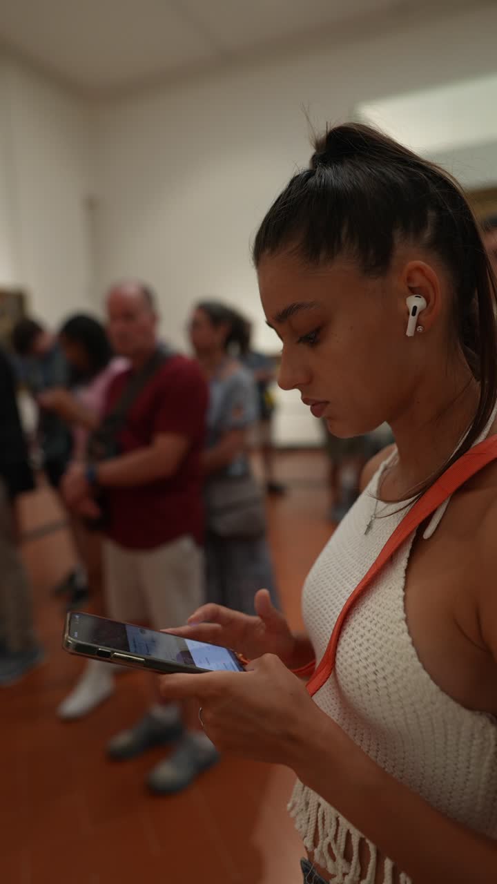 Woman using phone in an art museum