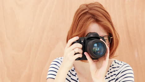 smiling hipster woman taking picture with camera