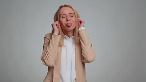 Cheerful-funny-bully-business-woman-showing-tongue-making-silly-faces-fooling-around-joking-teasing