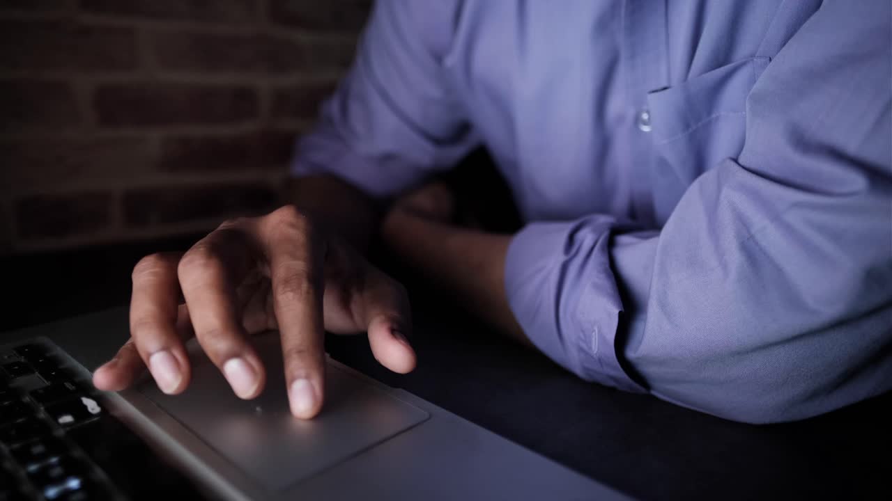 Person Working on Laptop at Night