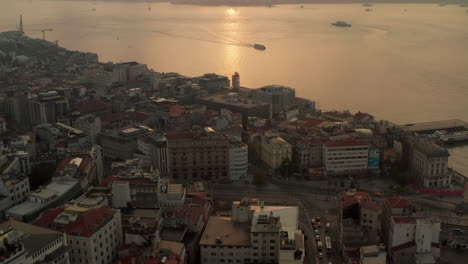 Early-Morning-Golden-Light-above-Istanbul,-Sunrise-over-the-Bosphorus-from-an-Aerial-Tilt-up-perspective