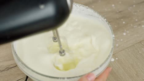 cream is whipped with an electric mixer to create a light texture for tiramisu filling.