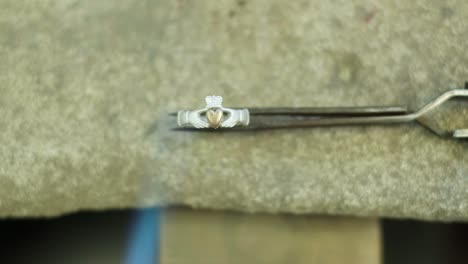 close ups of a craftsman making jewellery in a workshop