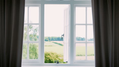 Bedroom-Curtains-Closing-On-View-Of-Countryside-Through-Window