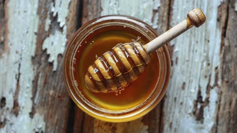 a jar of honey with a dipper