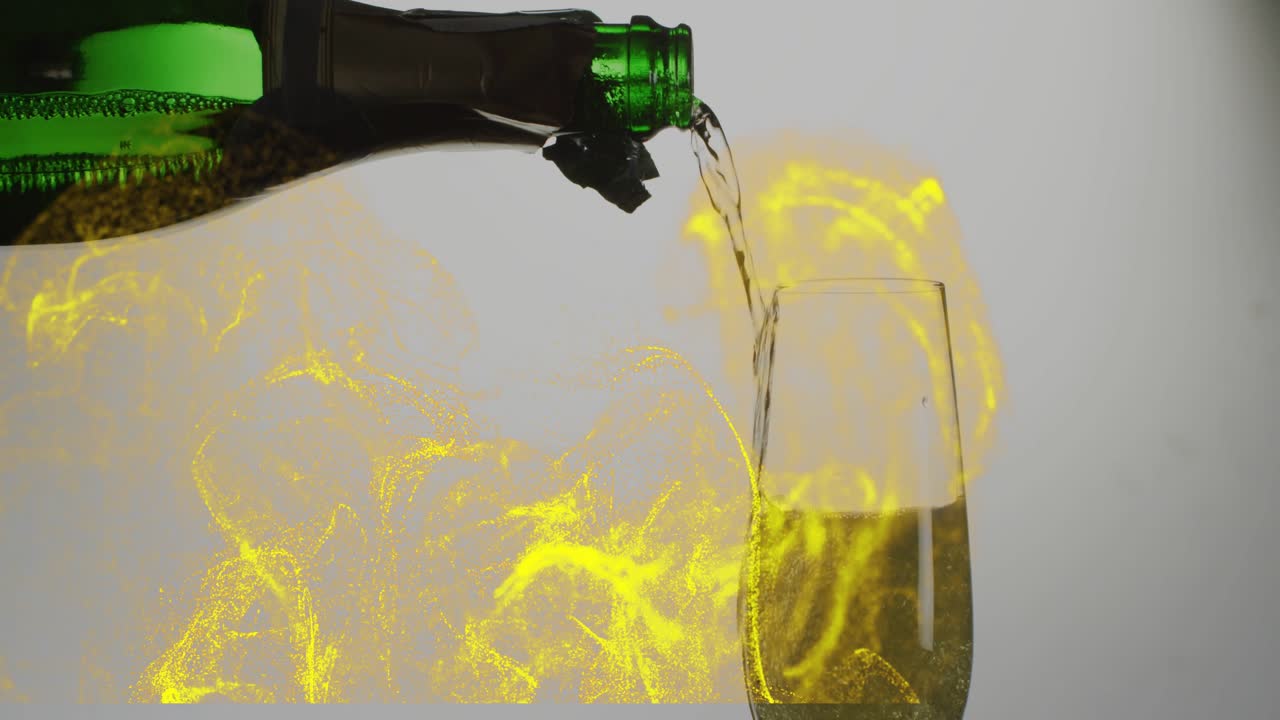 Tilting green bottle pouring pale champagne into flute, yellow swirls rising, filling glass