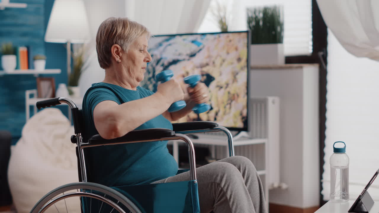Old woman with disability using dumbbells to exercise