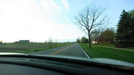 Driving-Down-Road-at-Sunset---View-from-Passenger-Seat