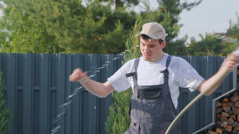 man having fun with a garden hose