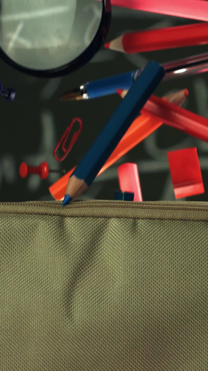 Colorful School Supplies Falling into a Pencil Case in Slow Motion
