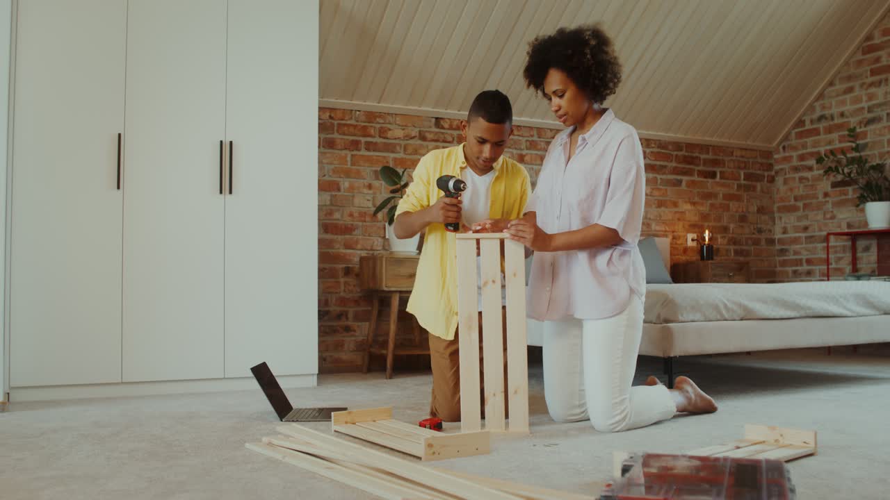 Mother and Son Assembling a Wooden Box