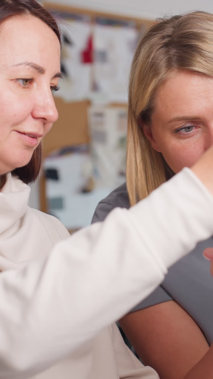 Women approve design, Celebration during pattern approval, Women check markings and plan packaging, Two women enthusiastically approve final pattern and organize packaging plans for execution