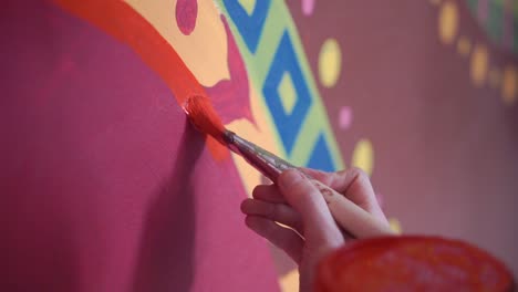 person painting a mural