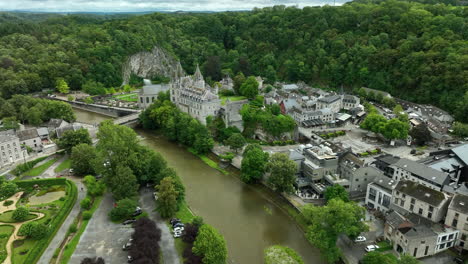 Aerial-toward-quaint-Durbuy-Castle-on-bank-of-Ourthe-River,-Belgium