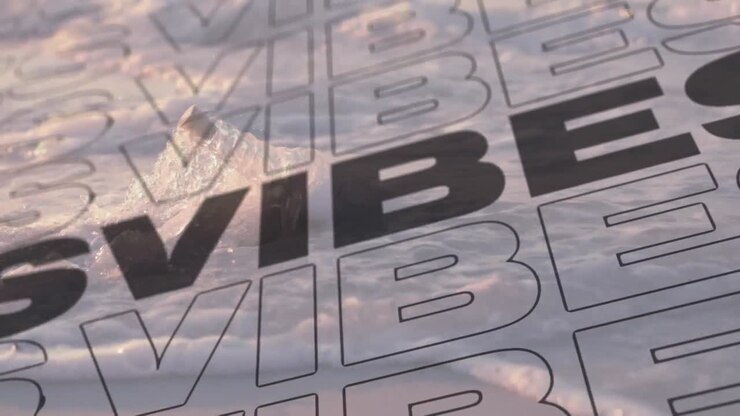 Animation of the word vibes in diagonal repeat moving over bottle on beach in shallow sea