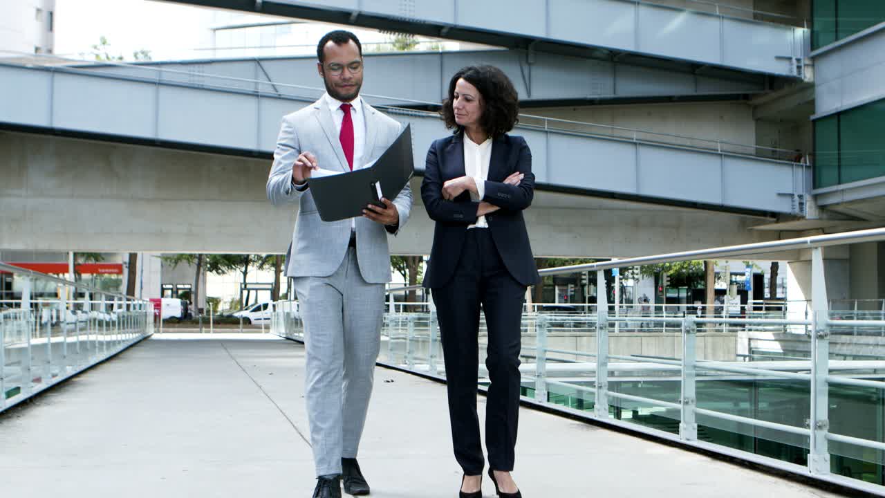 Smiling business people discussing papers