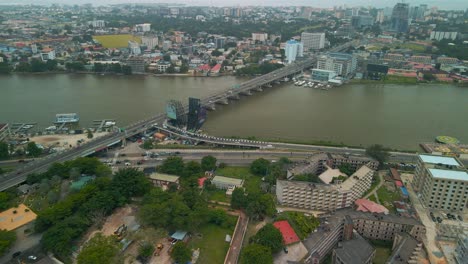 Traffic-and-cityscape-of-Victoria-Island,-Lagos,-Nigeria-featuring-Falomo-Bridge,-Lagos-Law-school-and-the-Civic-centre-tower