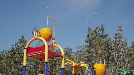 Colorful-Water-Buckets-Attraction-In-A-Playground-Inside-A-Swimming-Pool---wide-shot