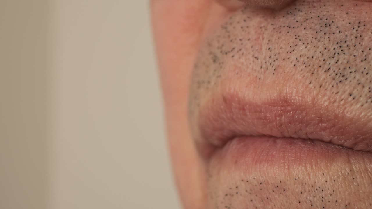 A man takes cough syrup internally. Close-up.