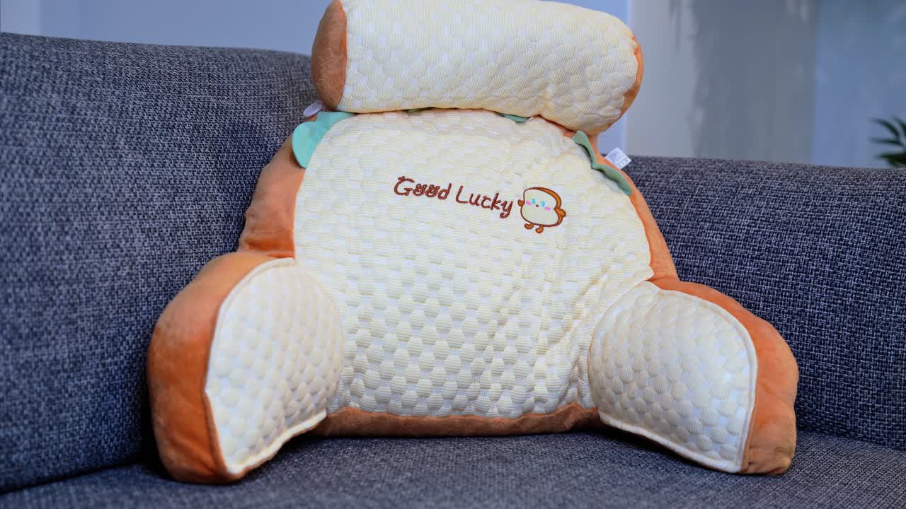 Charming pastel cushion with embroidery detail on sofa—ideal for home decor, lifestyle, or kids’ comfort themes