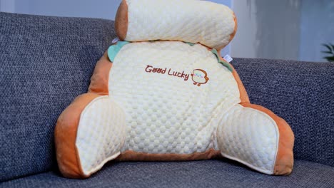 charming pastel cushion with embroidery detail on sofa—ideal for home decor, lifestyle, or kids’ comfort themes