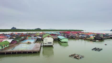 aerial view panning across floating village at panyee island in thailand