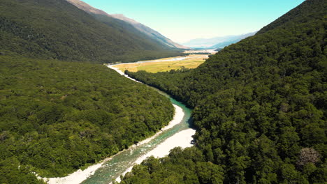 deep valley and river in new zealand, blue pools area, aerial drone view