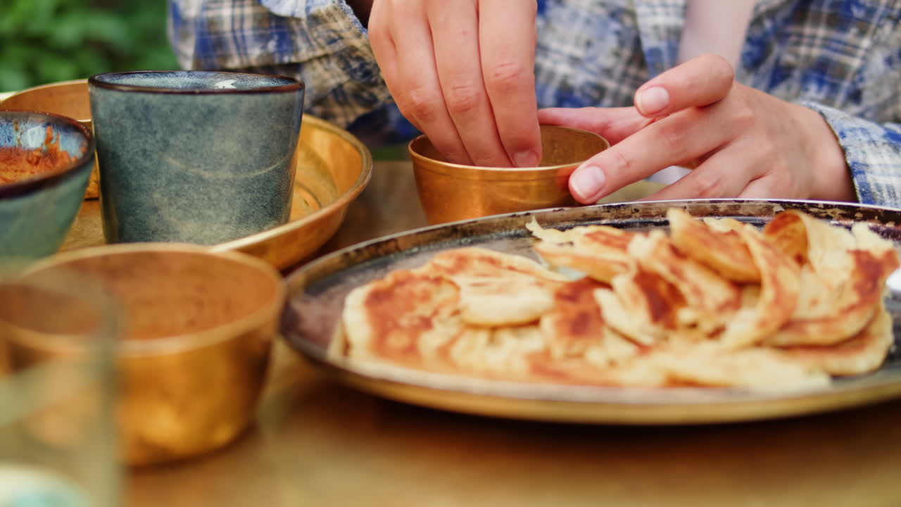 Person eating Indian roti with hands