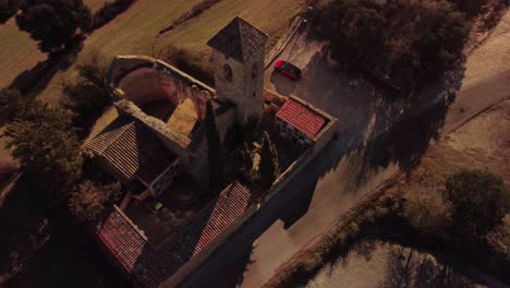 A-historic-stone-building-and-tower-in-marganell-region,-barcelona,-spain,-aerial-view