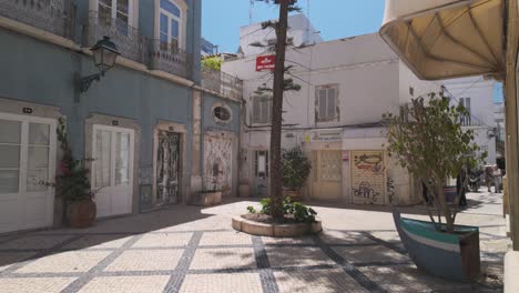 charming courtyard in olhão portugal with calçada pavement old buildings and potted trees