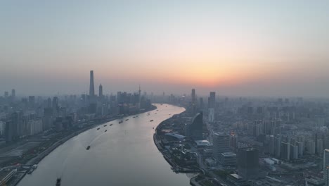 drone aerial view of sunset in huangpu river downtown shanghai china