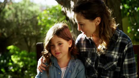 Mother-interacting-with-daughter-in-garden