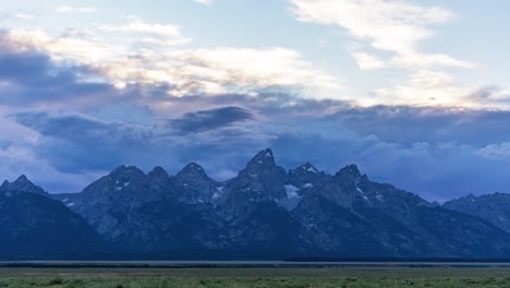 dramatic and moody sunset time lapse of clouds of teton range in grand teton national park