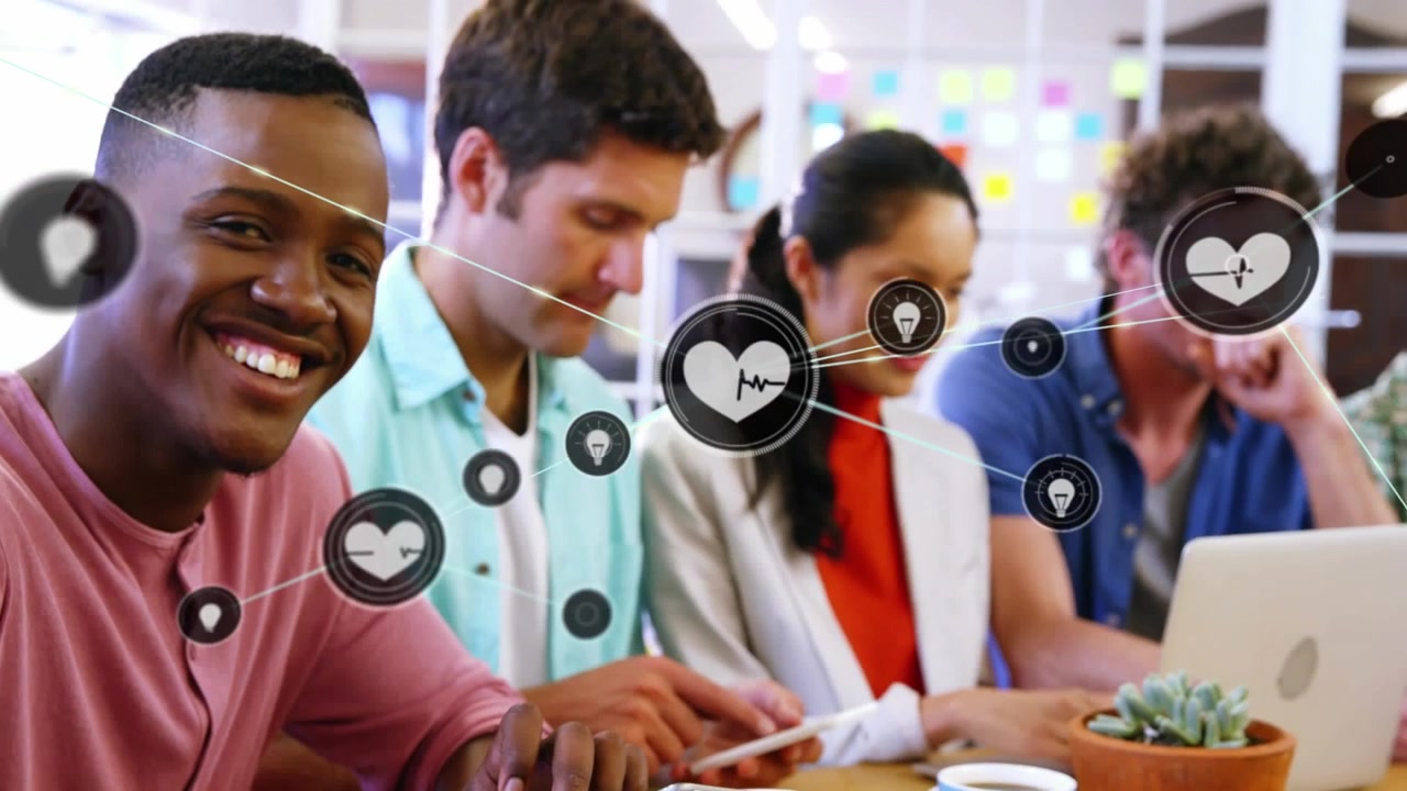 Animation of network of icons over african american man using digital tablet smiling at office