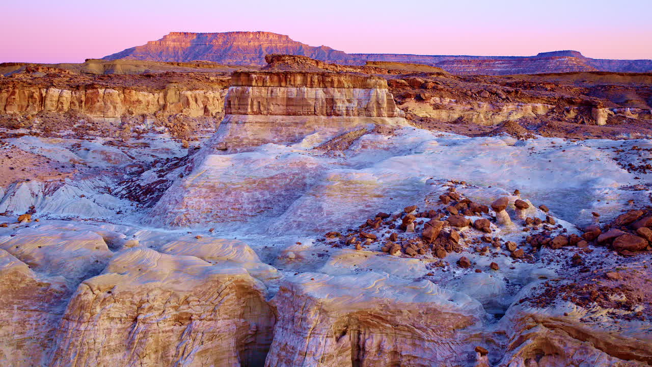 Drone footage moves slowly and dramatically over the colorful hills, intriguing rock structures, and hoodoos near the Utah-Arizona border.