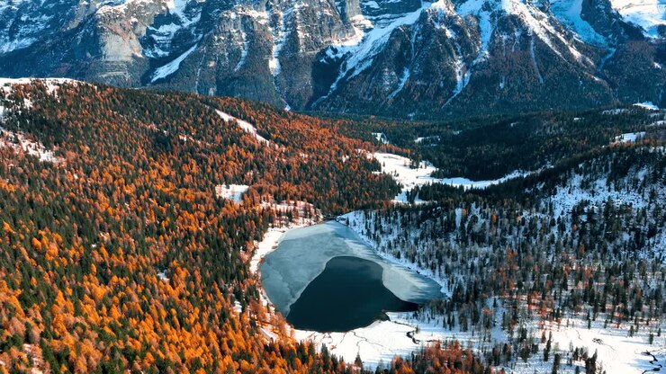 Aerial Drone View of Malghette's Lake in front of Brenta Dolomites at Fall - Graded