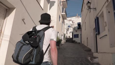 Slow-motion,-millennial-traveler-walking-up-narrow-European-alleyway-street