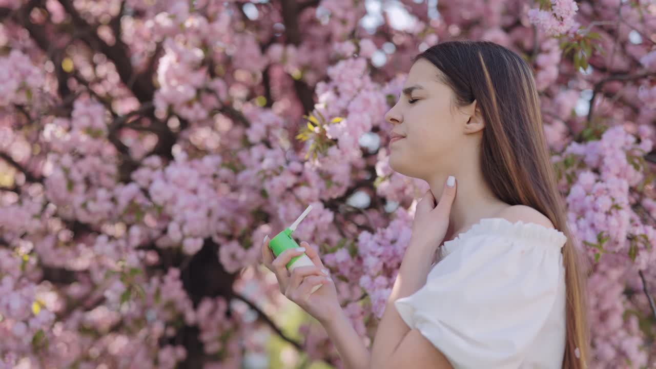 Teenager Using Inhaler Amongst Cherry Blossoms