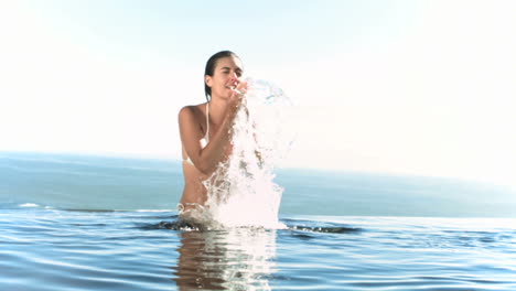 woman splashing water on her face in slow motion