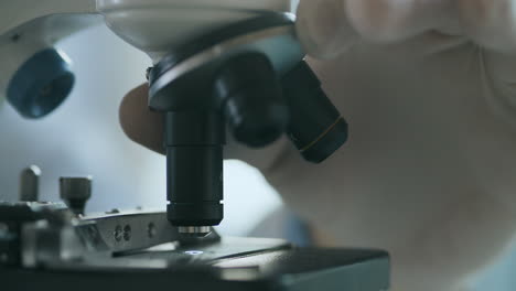 close-up shot of microscope at laboratory. researchers working in lab with microscope. examining of test sample under the microscope in laboratory. high quality 4k footage