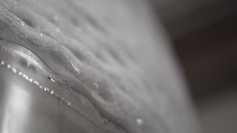 closeup of ice on a chilled brewery fermenter - 30 fps